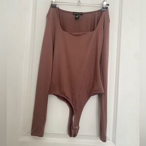 Purple double lined body suit from love shop. Body con,never worn,woman’s small.